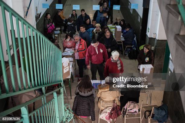 Voters check in at a polling center before casting ballots during a primary election in Buenos Aires, Argentina, on Sunday, Aug. 13, 2017....