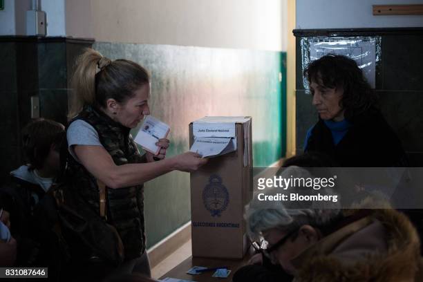 Voter casts a ballot at a polling center during a primary election in Buenos Aires, Argentina, on Sunday, Aug. 13, 2017. Argentinians are voting to...