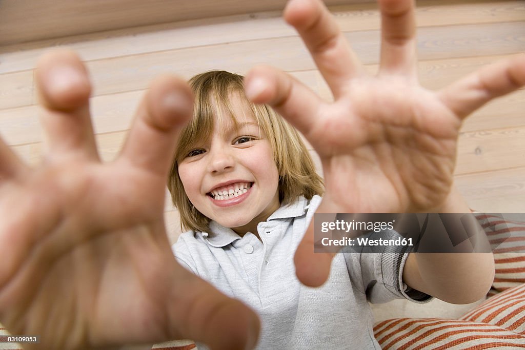 Boy (8-9) making faces, portrait