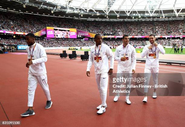 Chijindu Ujah, Nethaneel Mitchell-Blake, Adam Gemili and Daniel Talbot of Great Britain, gold, pose with their medals for the Men's 4x100 Metres...