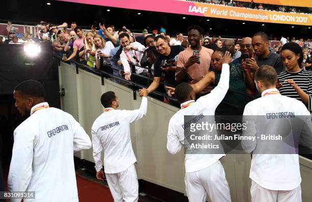 Chijindu Ujah, Adam Gemili, Daniel Talbot and Nethaneel Mitchell-Blake of Great Britain, gold, celebarte with fans after recieving their medals for...