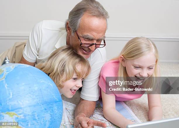 grandfather and grandchildren (8-9) having fun, laughing, portrait - geheimratsecke stock-fotos und bilder