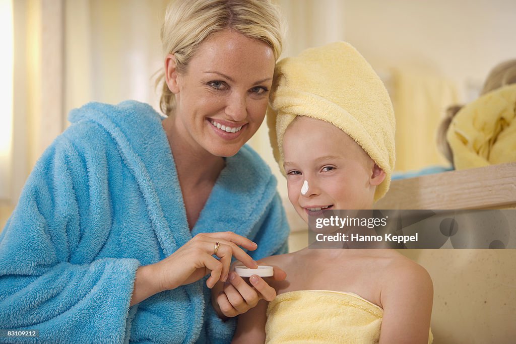 Mother with daughter (8-9) in bathroom