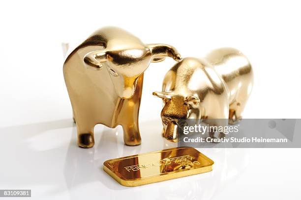 bull and bear sculptures by gold bar - bull bear stock-fotos und bilder