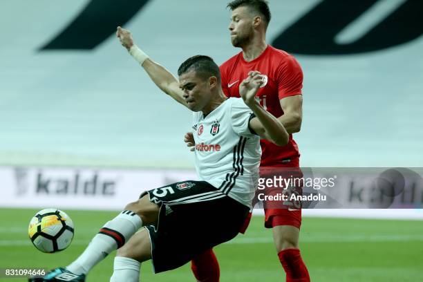 Pepe of Besiktas is in action against Ondrej Celustka of Antalyaspor during a Turkish Spor Toto Super Lig soccer match between Besiktas JK and...