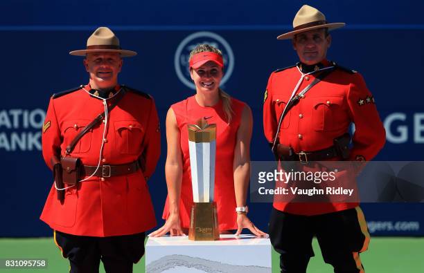 Elina Svitolina of Ukraine and Canadian Mounties with the winners trophy after defeating Caroline Wozniacki of Denmark following the final match on...
