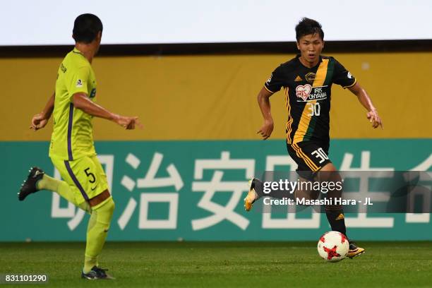 Takuma Nishimura of Vegalta Sendai takes on Kazuhiko Chiba of Sanfrecce Hiroshima during the J.League J1 match between Vegalta Sendai and Sanfrecce...