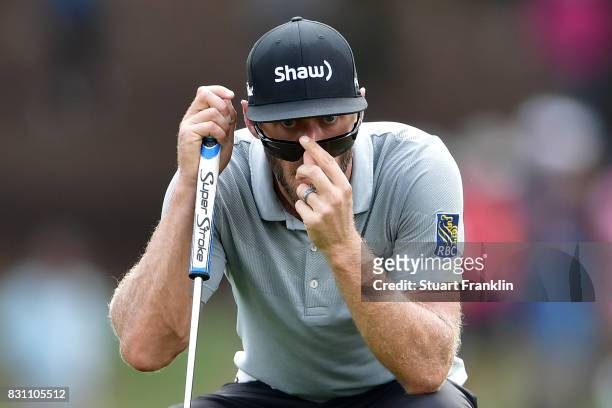 Graham DeLaet of Canada lines up a putt on the second green during the final round of the 2017 PGA Championship at Quail Hollow Club on August 13,...
