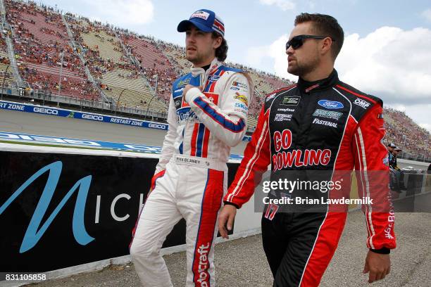 Ryan Blaney, driver of the Motorcraft/SKF Ford, talks to Ricky Stenhouse Jr., driver of the Go Bowling Ford, on the grid prior to the Monster Energy...