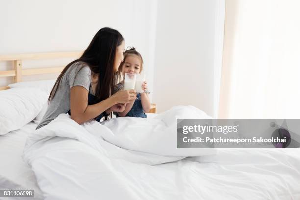 mother and daughter drinking milk - child wearing adult glasses stock pictures, royalty-free photos & images