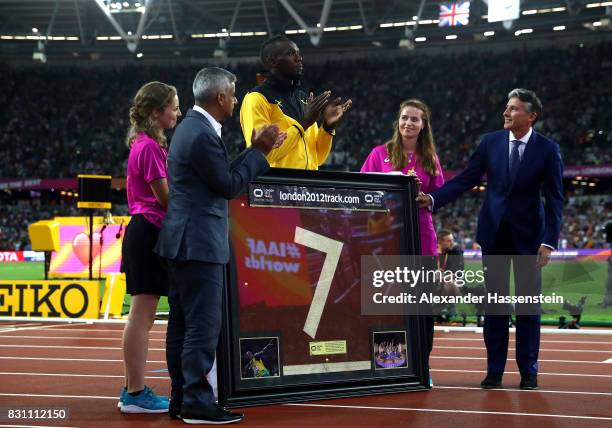 Usain Bolt of Jamaica is presented with a framed piece of the track from the London 2012 Olympics IAAF President Sebastian Coe and Mayor of London...