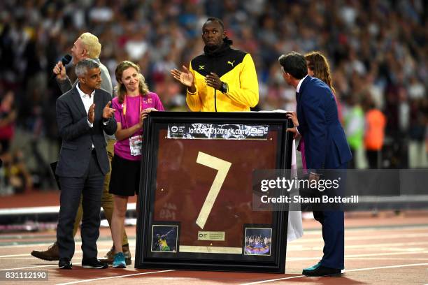 Usain Bolt of Jamaica is presented with a framed piece of the track from the London 2012 Olympics IAAF President Sebastian Coe and Mayor of London...