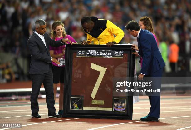 Usain Bolt of Jamaica is presented with a framed piece of the track from the London 2012 Olympics IAAF President Sebastian Coe and Mayor of London...