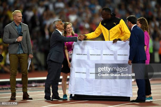 Usain Bolt of Jamaica is presented with a framed piece of the track from the London 2012 Olympics IAAF President Sebastian Coe and Mayor of London...