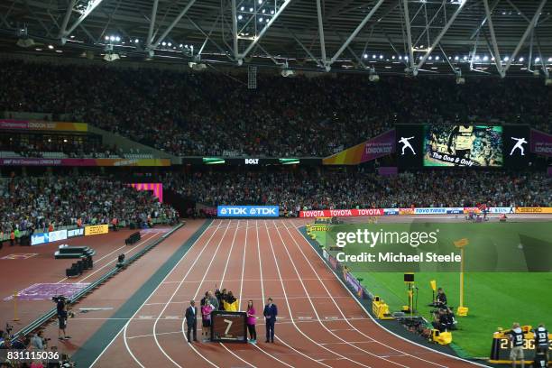 Usain Bolt of Jamaica is presented with a framed piece of the track from the London 2012 Olympics IAAF President Sebastian Coe and Mayor of London...