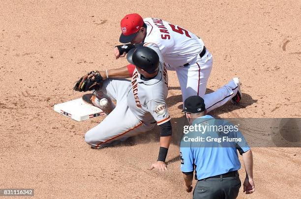 Ryder Jones of the San Francisco Giants steals second base in the eighth inning ahead of the tag of Adrian Sanchez of the Washington Nationals during...