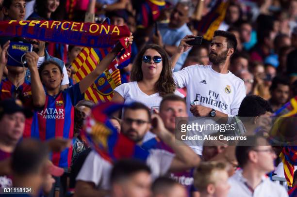 Supporter of Real Madrid CF takes pictures with his mobile phone during the Supercopa de Espana Supercopa Final 1st Leg match between FC Barcelona...