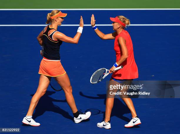 Ekaterina Makarova of Russia celebrates a point with partner Elena Vesnina of Russia as they compete against Anna-Lena Groenefeld of Germany and...
