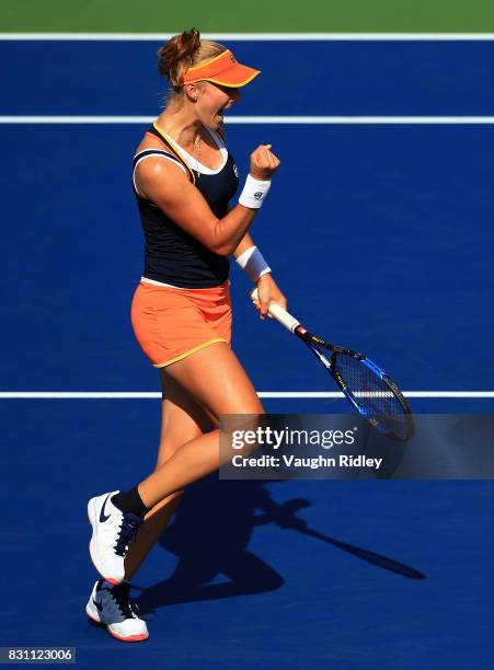 Ekaterina Makarova of Russia celebrates a point with partner Elena Vesnina of Russia as they compete against Anna-Lena Groenefeld of Germany and...