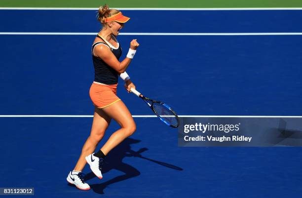Ekaterina Makarova of Russia celebrates a point with partner Elena Vesnina of Russia as they compete against Anna-Lena Groenefeld of Germany and...