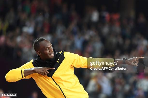 Jamaica's Usain Bolt does his trademark gesture as he takes part in a lap of honour on the final day of the 2017 IAAF World Championships at the...