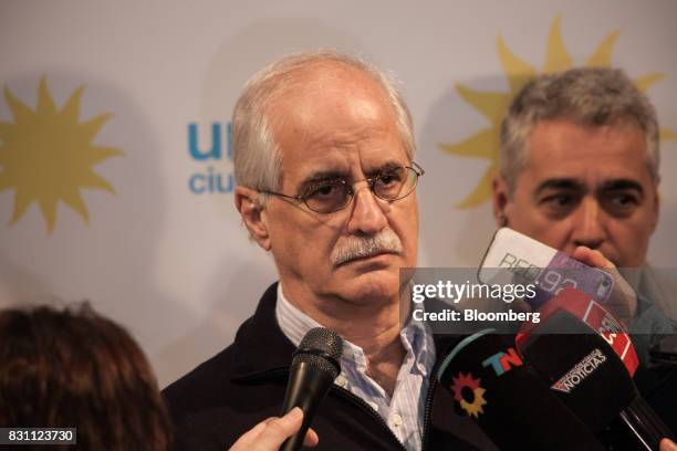 Jorge Taiana, former foreign minister of Argentina, listens to members of the media at the Unidad Ciudadana party headquarters during a primary...