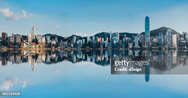 victoria harbour with panoramic view of hong kong city skyline - hongkong stock pictures, royalty-free photos & images