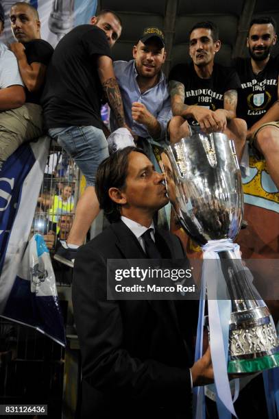Lazio head coah Simone Inzaghi with the cup after the Italian Supercup match between Juventus and SS Lazio at Stadio Olimpico on August 13, 2017 in...