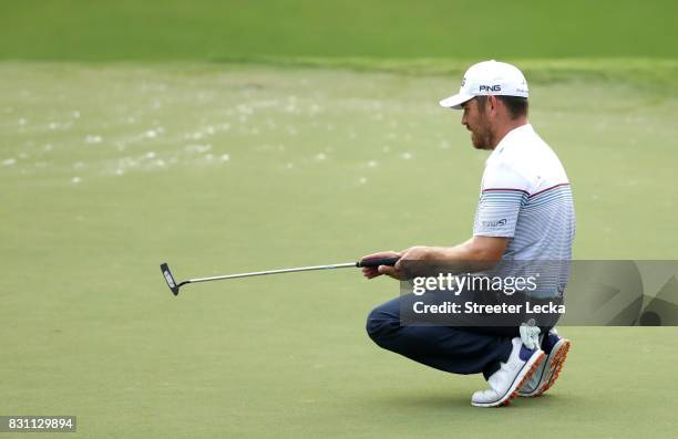 Louis Oosthuizen of South Africa reacts to his putt on the 13th green during the final round of the 2017 PGA Championship at Quail Hollow Club on...