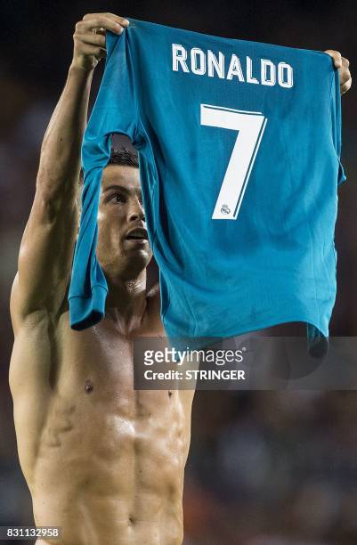 Real Madrid's Portuguese forward Cristiano Ronaldo shows his jersey to celebrate his goal during the first leg of the Spanish Supercup football match...