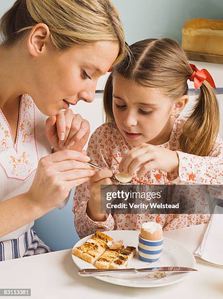 mother and daughter eating breakfast - kid boiled egg stock pictures, royalty-free photos & images