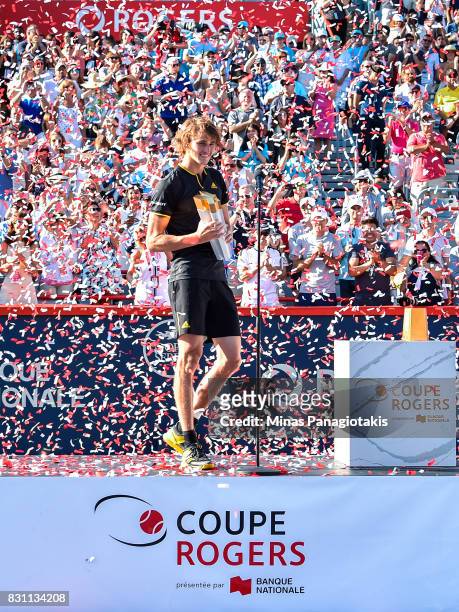 Confetti is blown as Alexander Zverev of Germany makes his way onto the stage with the trophy after defeating Roger Federer of Switzerland 6-3, 6-4...