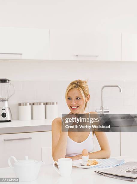 woman sitting at breakfast table - hard boiled eggs stock pictures, royalty-free photos & images