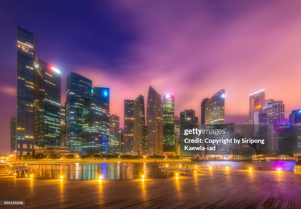 The Central Business District (CBD) Buildings around the Marina Bay in Singapore at dawn.