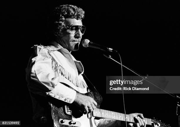 Rockabilly and country singer Carl Perkins performs on October 11, 1986 in Atlanta, Georgia.