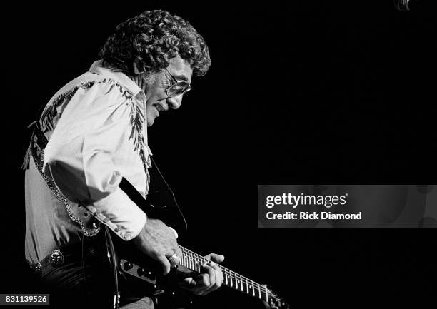 Rockabilly and country singer Carl Perkins performs on October 11, 1986 in Atlanta, Georgia.