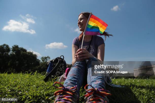 Participant hold a small rainbow flag commonly known as the LGBT pride flag with the inscription 'Love is stronger than hatred' during the Gay Pride...