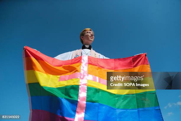 Participant hold a rainbow flag commonly known as the LGBT pride flag with the inscription 'Love is stronger than hatred' during the Gay Pride...