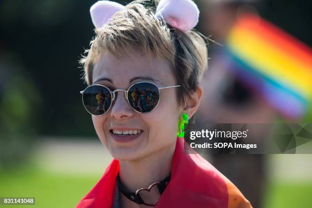 People attending a rally are reflected on a participant's sunglasses during the Gay Pride demonstration in Field of Mars. Several dozens of people...