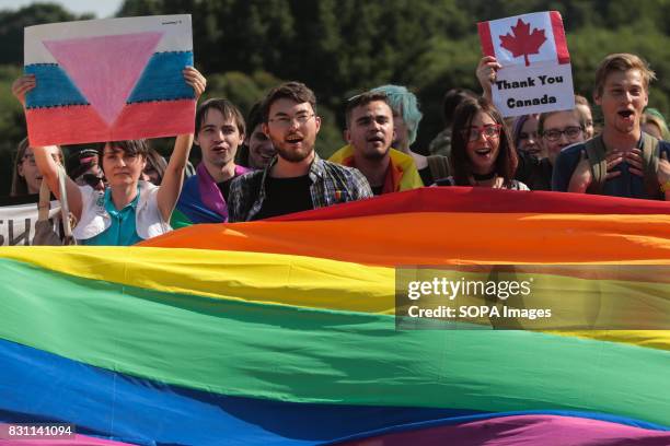 Participants hold a rainbow flag commonly known as the LGBT pride flag during the Gay Pride demonstration in Field of Mars. Several dozens of people...