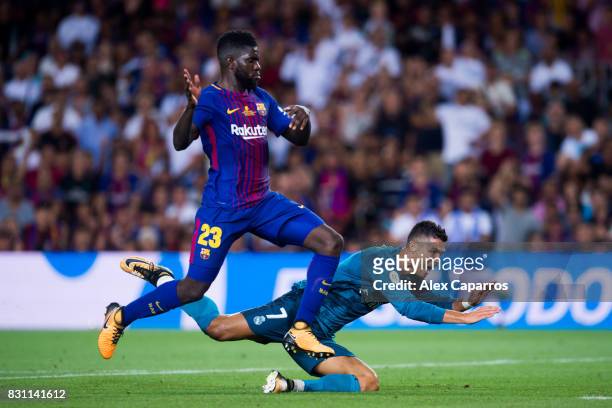 Cristiano Ronaldo of Real Madrid CF fights for the ball with Samuel Umtiti of FC Barcelona during the Supercopa de Espana Supercopa Final 1st Leg...
