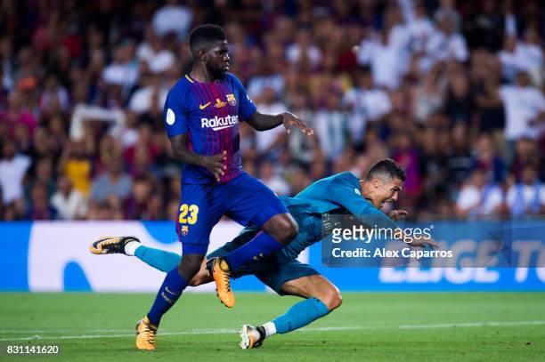 Cristiano Ronaldo of Real Madrid CF fights for the ball with Samuel Umtiti of FC Barcelona during the Supercopa de Espana Supercopa Final 1st Leg...