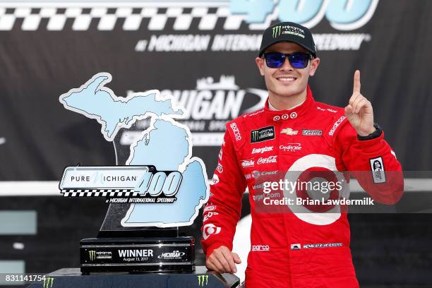 Kyle Larson, driver of the Target Chevrolet, celebrates in Victory Lane after winning the Monster Energy NASCAR Cup Series Pure Michigan 400 at...