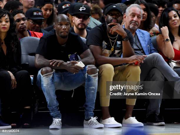 Former NFL player Chad Johnson and Dwyane Wade of the Chicago Bulls watch the game between Tri-State and Power during week eight of the BIG3 three on...