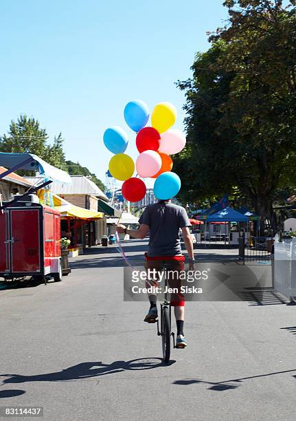 day at an amusement park - unicycle stock pictures, royalty-free photos & images
