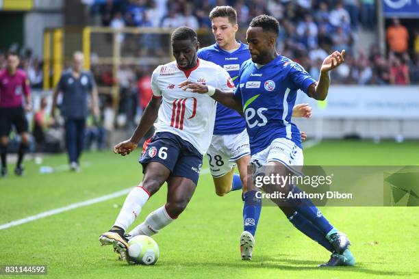 Ibrahim Amadou of Lille, Jonas Martin and Yoann Salmier of Strasbourg during the Ligue 1 match between Racing Club Strasbourg and Lille OSC at Stade...