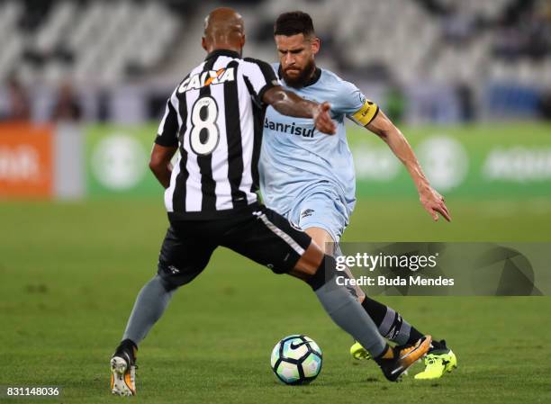 Bruno Silva of Botafogo struggles for the ball with Marcelo Oliveira of Gremio during a match between Botafogo and Gremio as part of Brasileirao...