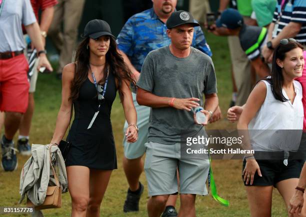 Rickie Fowler of the United States and Allison Stokke walk along the on the 18th green during the final round of the 2017 PGA Championship at Quail...
