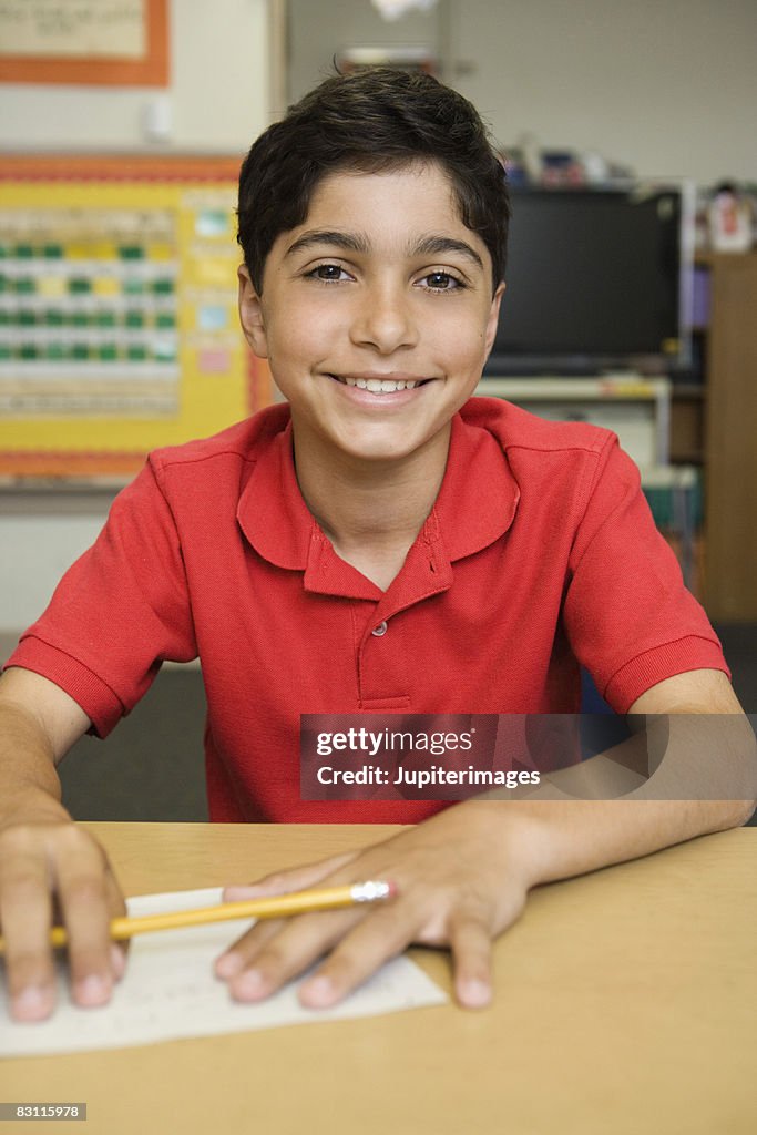 Smiling boy at desk