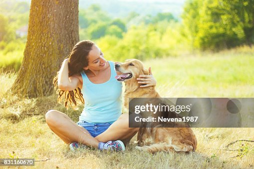Young woman having a fun with her dog Young woman having a fun with her dog